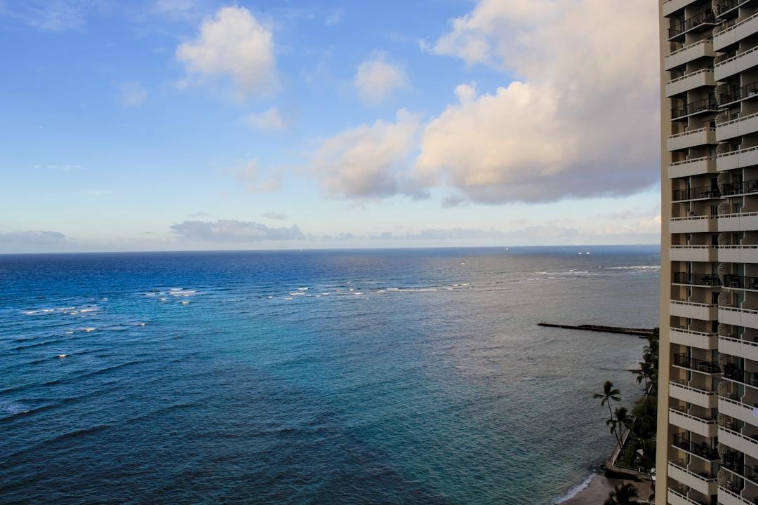 Ocean view from a high-rise building balcony.