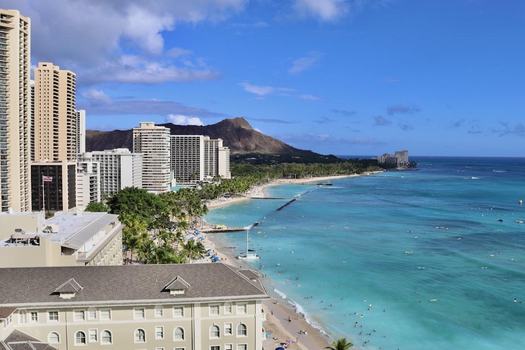 a view of a beach with buildings in the background