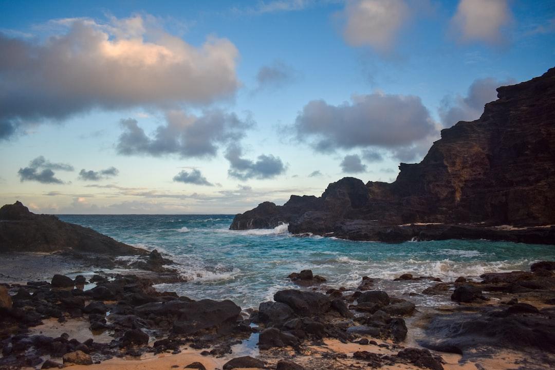 a rocky beach with a body of water